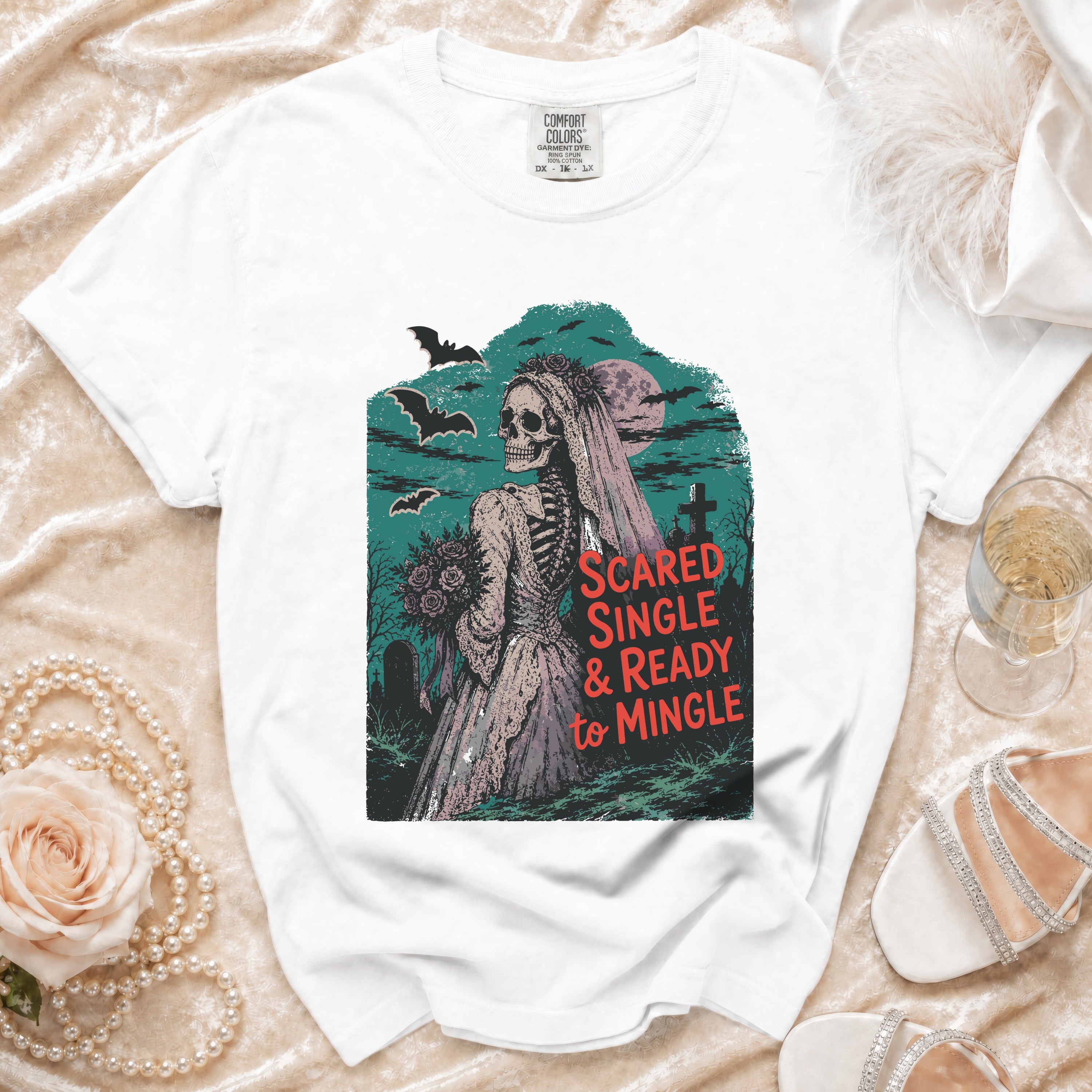White t-shirt featuring skeleton bride graphic with text "Scared Single & Ready to Mingle".