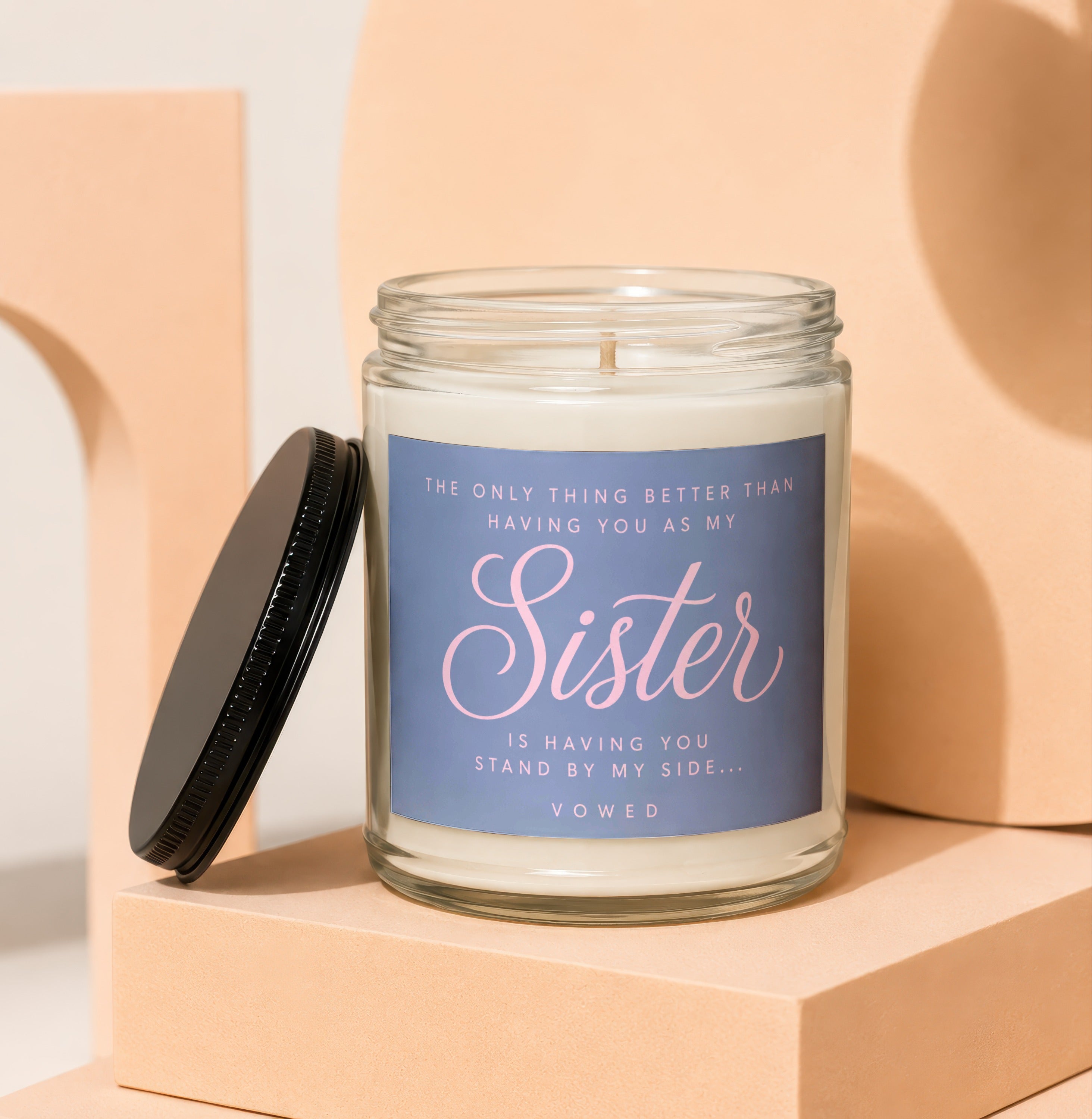 Glass candle with black lid, reads "Sister is having you stand by my side... Vowed."