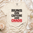 Light beige t-shirt with black and red text "RUNS ON CAFFEINE AND CHAOS".