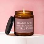 Thank You For Helping Us Tie The Knot candle with lit flame.