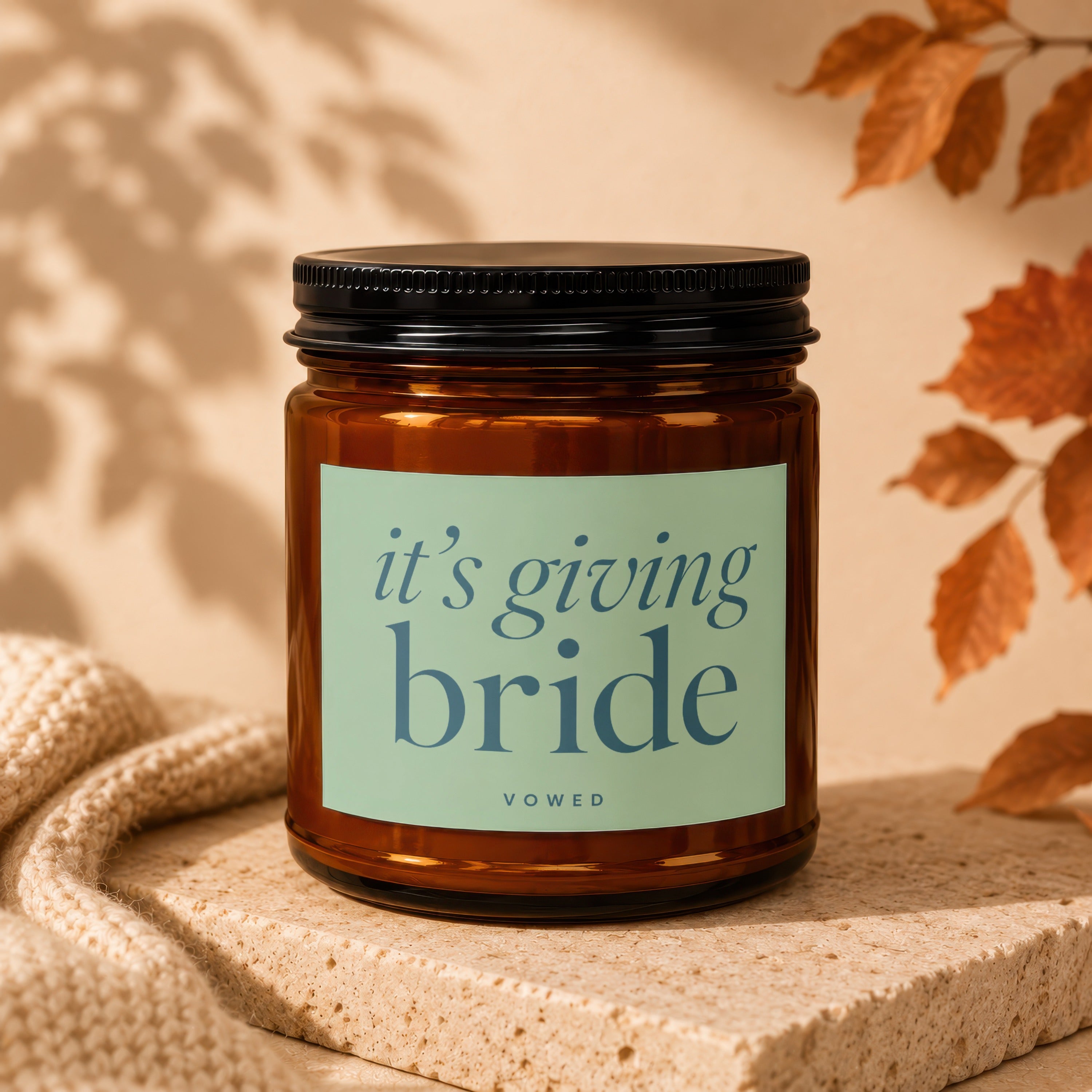 Amber jar candle with "it's giving bride" text, VOWED logo.