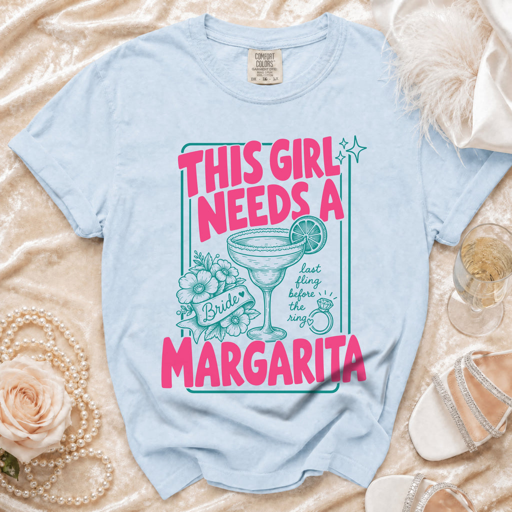Light blue Comfort Colors t-shirt with "This girl needs a margarita" graphic.