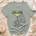 T-shirt with a margarita graphic and "This Girl Needs a Margarita" text.