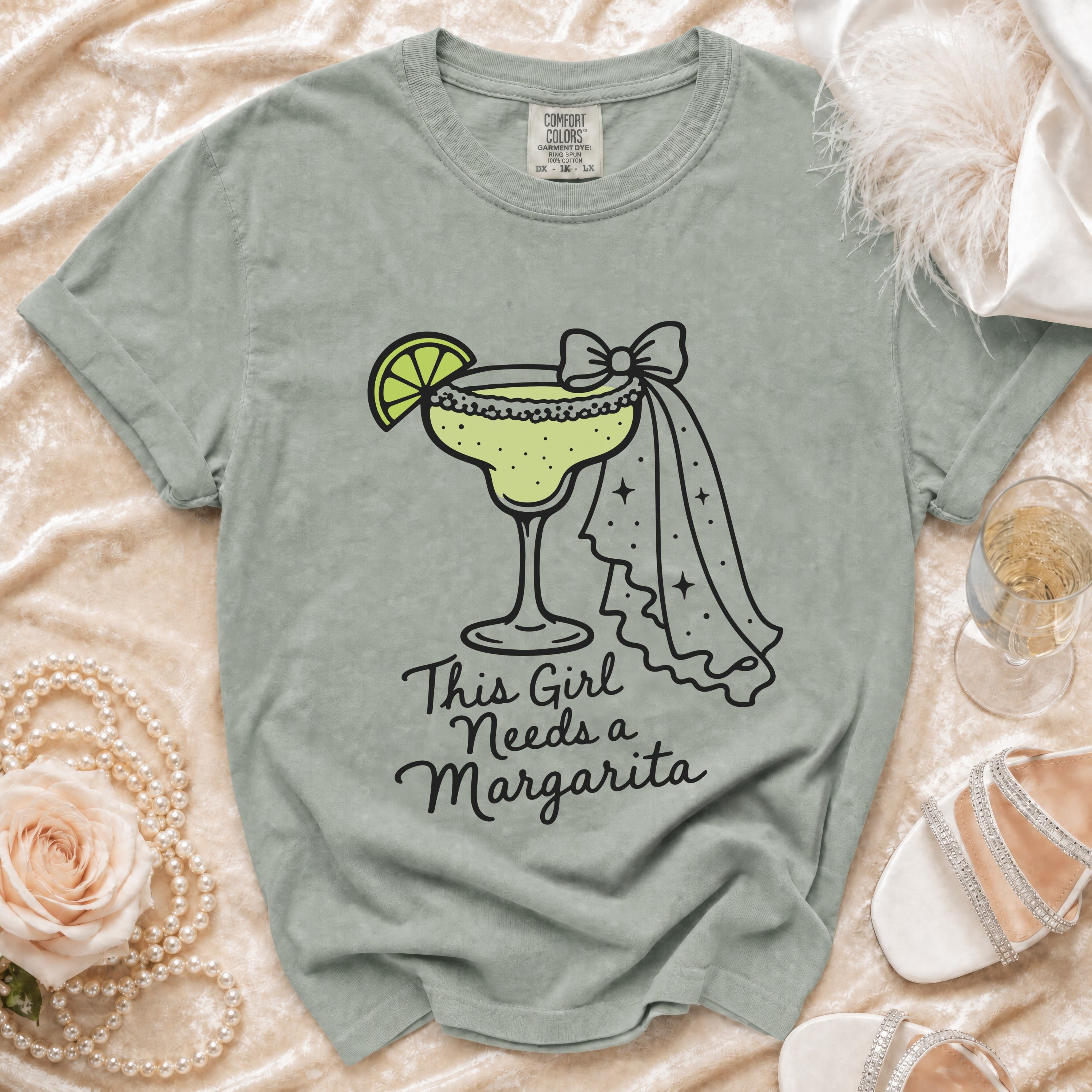 T-shirt with a margarita graphic and "This Girl Needs a Margarita" text.