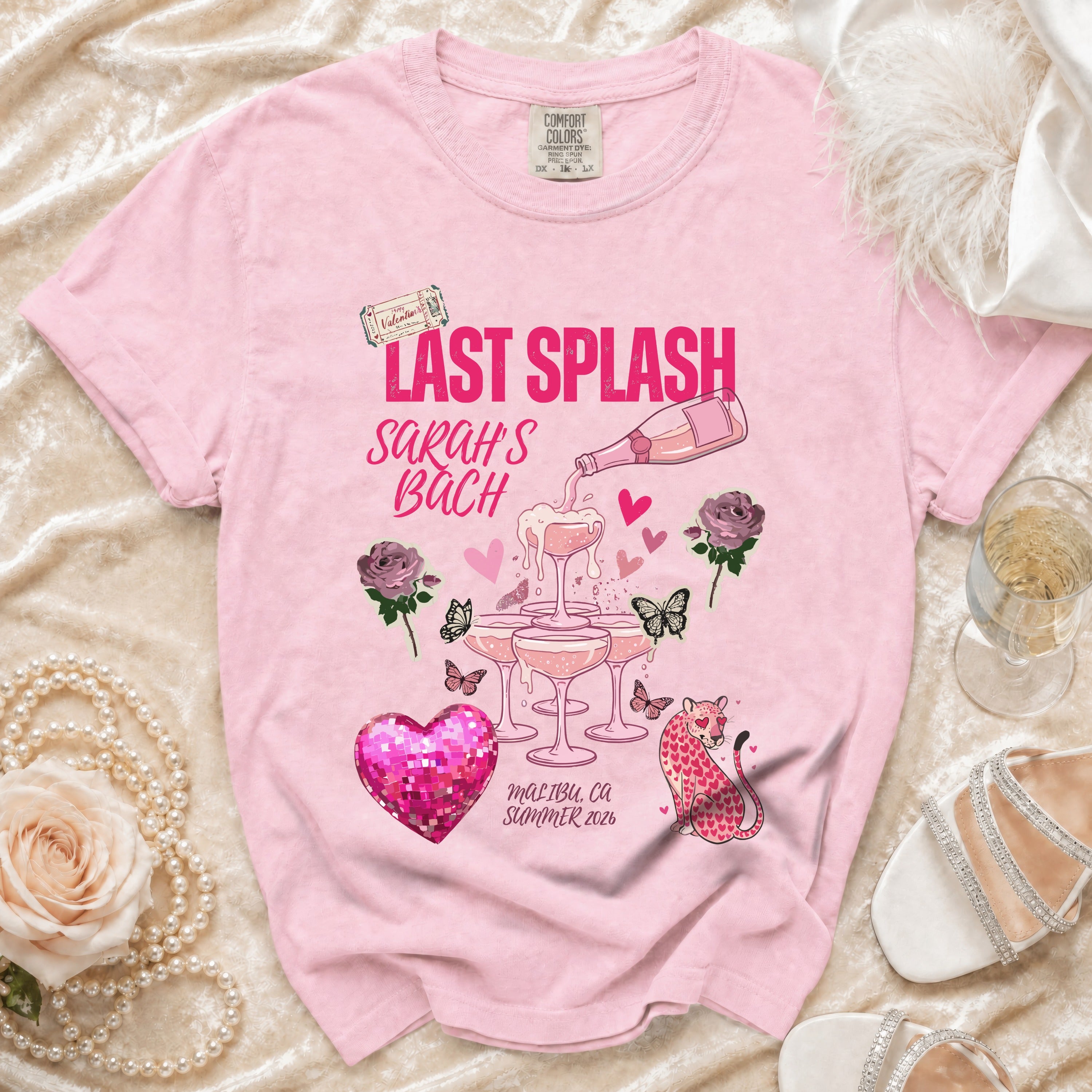 Pink t-shirt with "Last Splash Sarah's Bach" text and graphics.