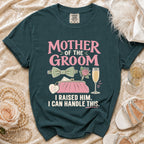 Dark green shirt with "MOTHER OF THE GROOM" text, purse, and wedding icons.