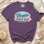 Purple t-shirt with "Forever Starts Here Just Married" graphic and wedding rings.