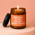 Amber jar candle with burning wick and text "Welcome to My Dream Budget Wedding VOWED".
