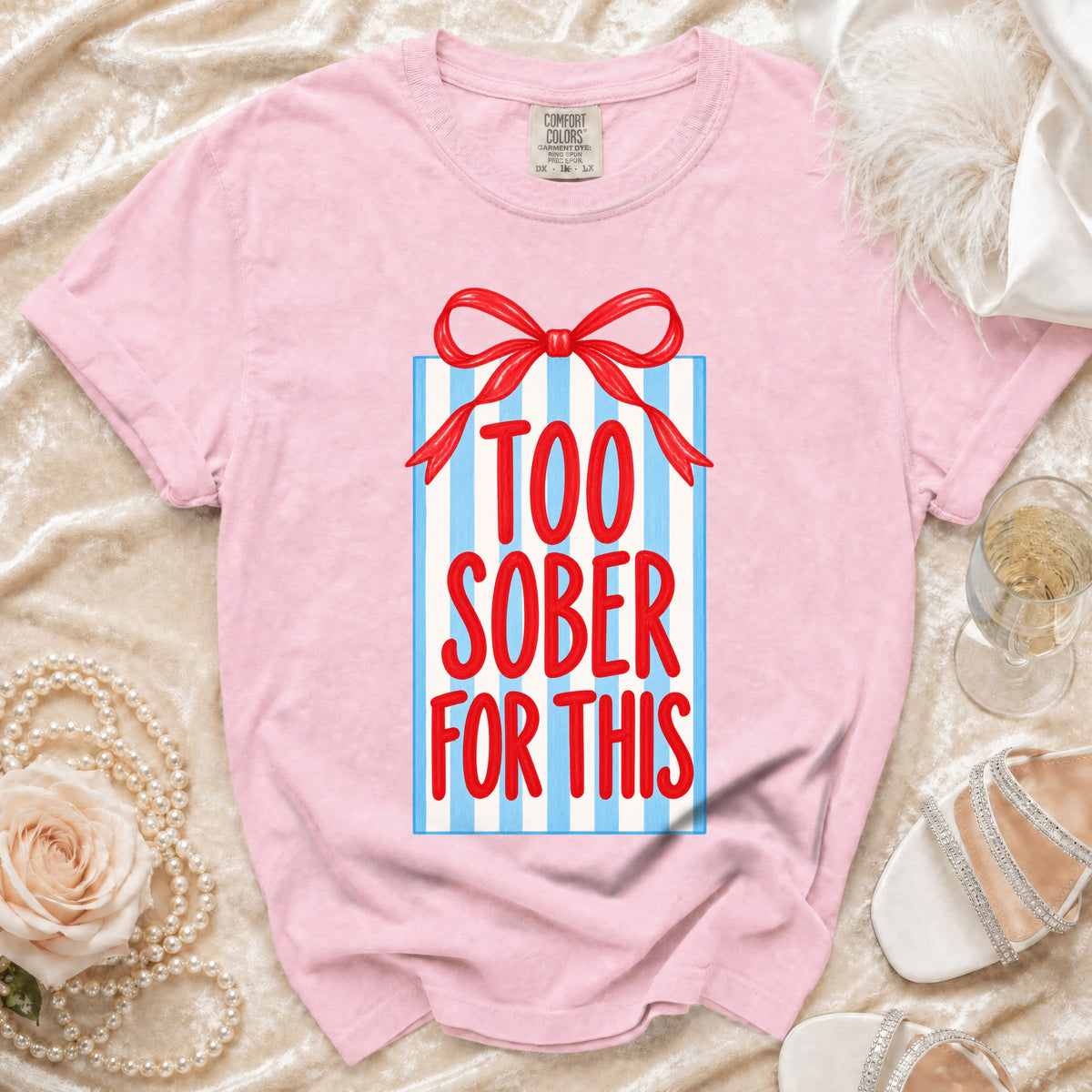 Pink t-shirt with a gift box graphic that reads "TOO SOBER FOR THIS."