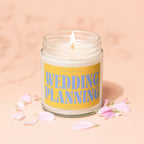 Scented candle with yellow label reading "Smells Like Wedding Planning".