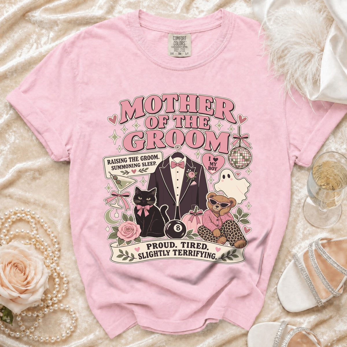 Pink t-shirt with "Mother of the Groom" graphic and humorous text.