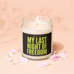 Burning candle in glass jar with "MY LAST NIGHT OF FREEDOM" on label.