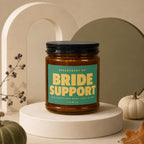 Amber jar candle labeled "Bride Support" with decorative elements.
