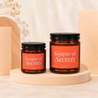 Two glass jars labeled "Keeper of Secrets" in different sizes.
