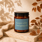 Amber jar candle "Keeper of the Emergency Kit" with a blue label.