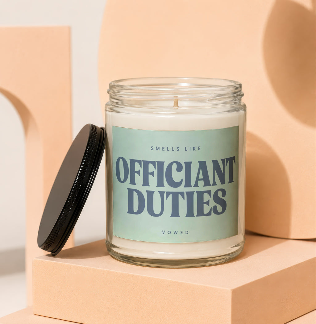 Glass candle with label "Smells Like Officiant Duties Vowed."