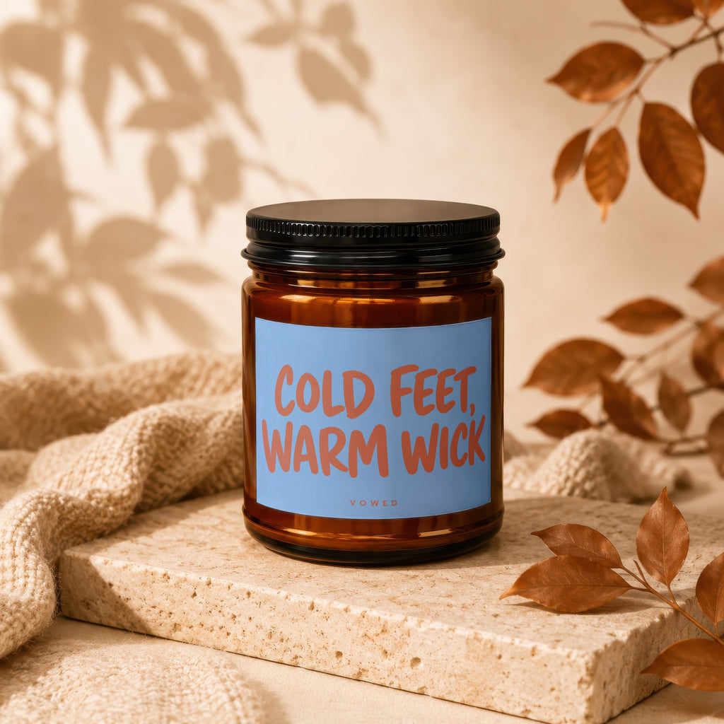 Brown candle with "Cold Feet, Warm Wick" text on a light blue label.