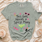 Green t-shirt with "This Girl Needs a Spicy Marg" text and margarita graphic.