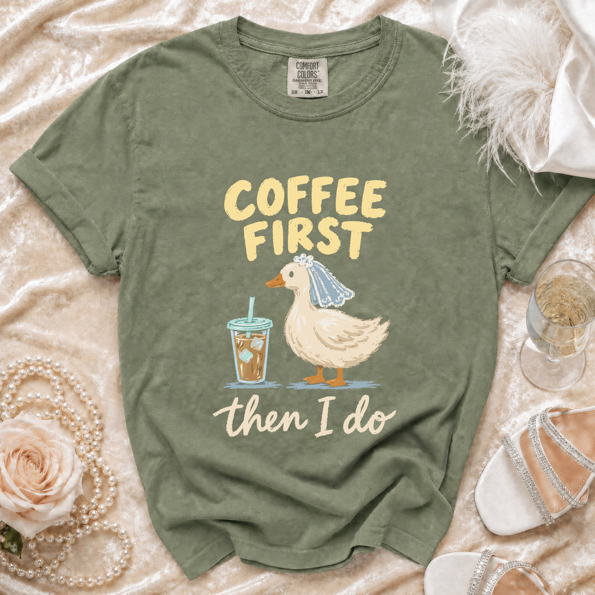Green t-shirt with "Coffee First then I Do" text and duck graphic.