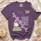 Purple t-shirt with "LUCKY" graphic, ghost, and text about the bride.