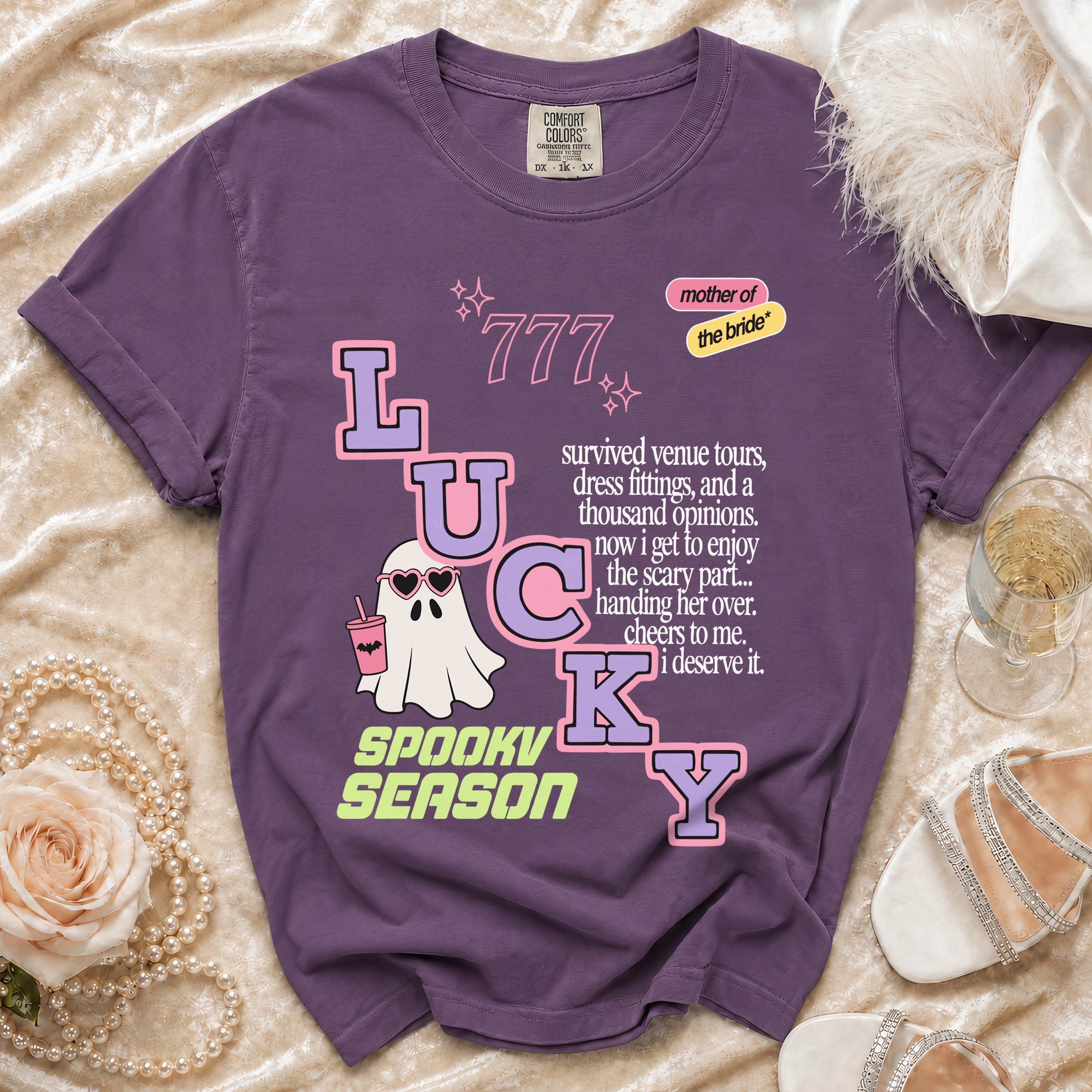 Purple t-shirt with "LUCKY" graphic, ghost, and text about the bride.