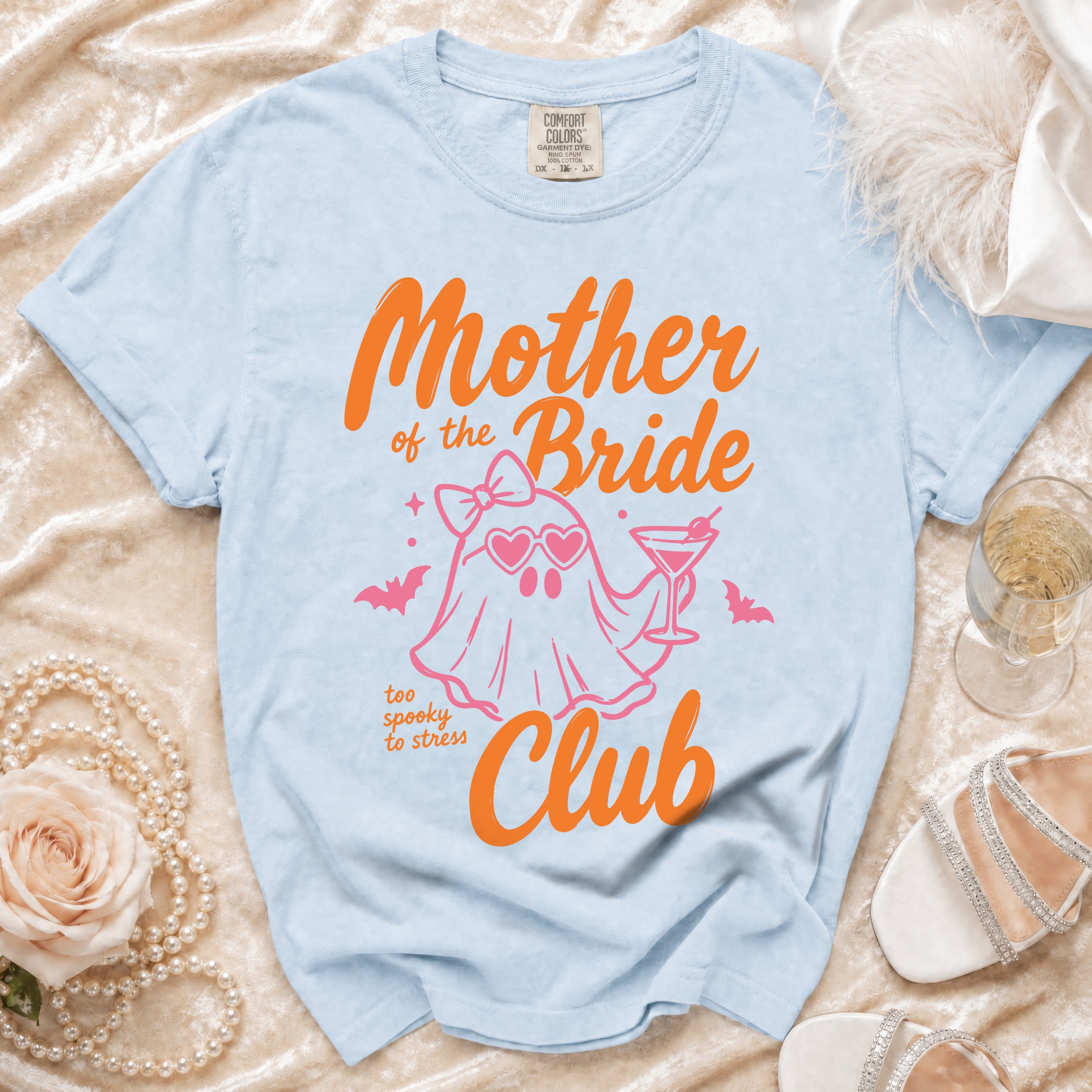 Light blue t-shirt with "Mother of the Bride Club" text and a ghost graphic.