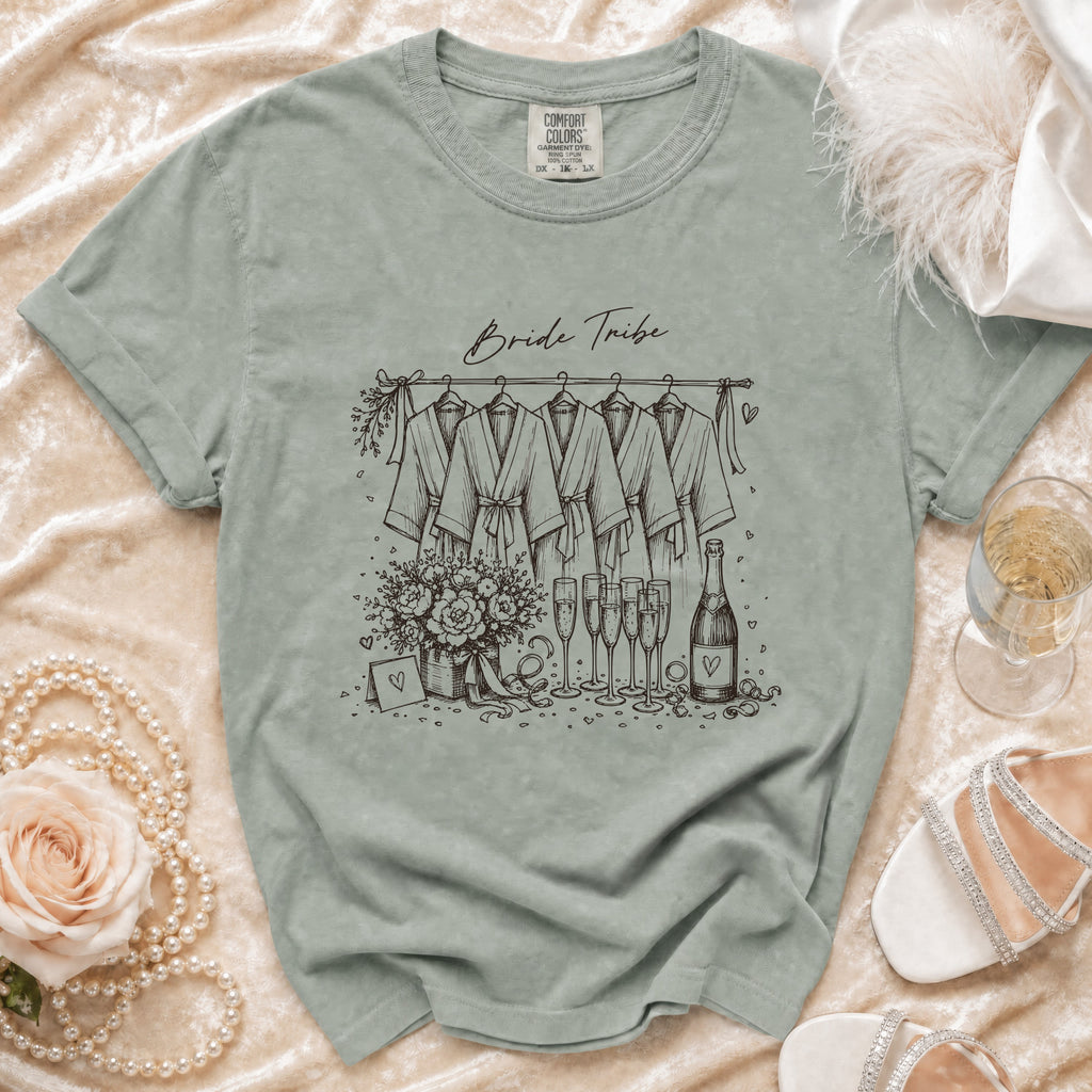 T-shirt with "Bride Tribe" graphic showing robes, flowers, champagne, and a bottle.