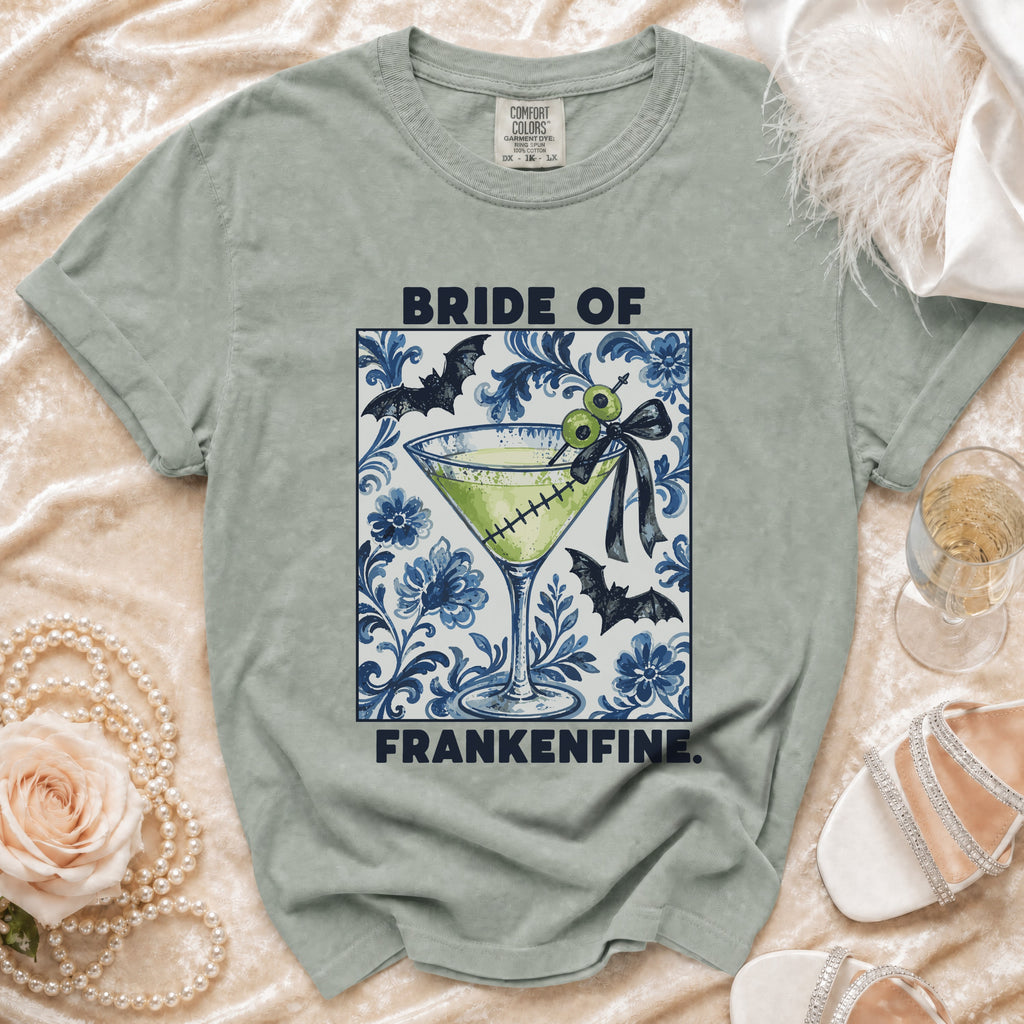 T-shirt graphic: "Bride of Frankenfine" with martini glass, bats, and floral pattern.