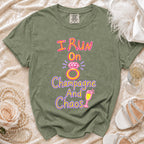 Olive green t-shirt with "I Run On Champagne And Chaos" text and graphics.