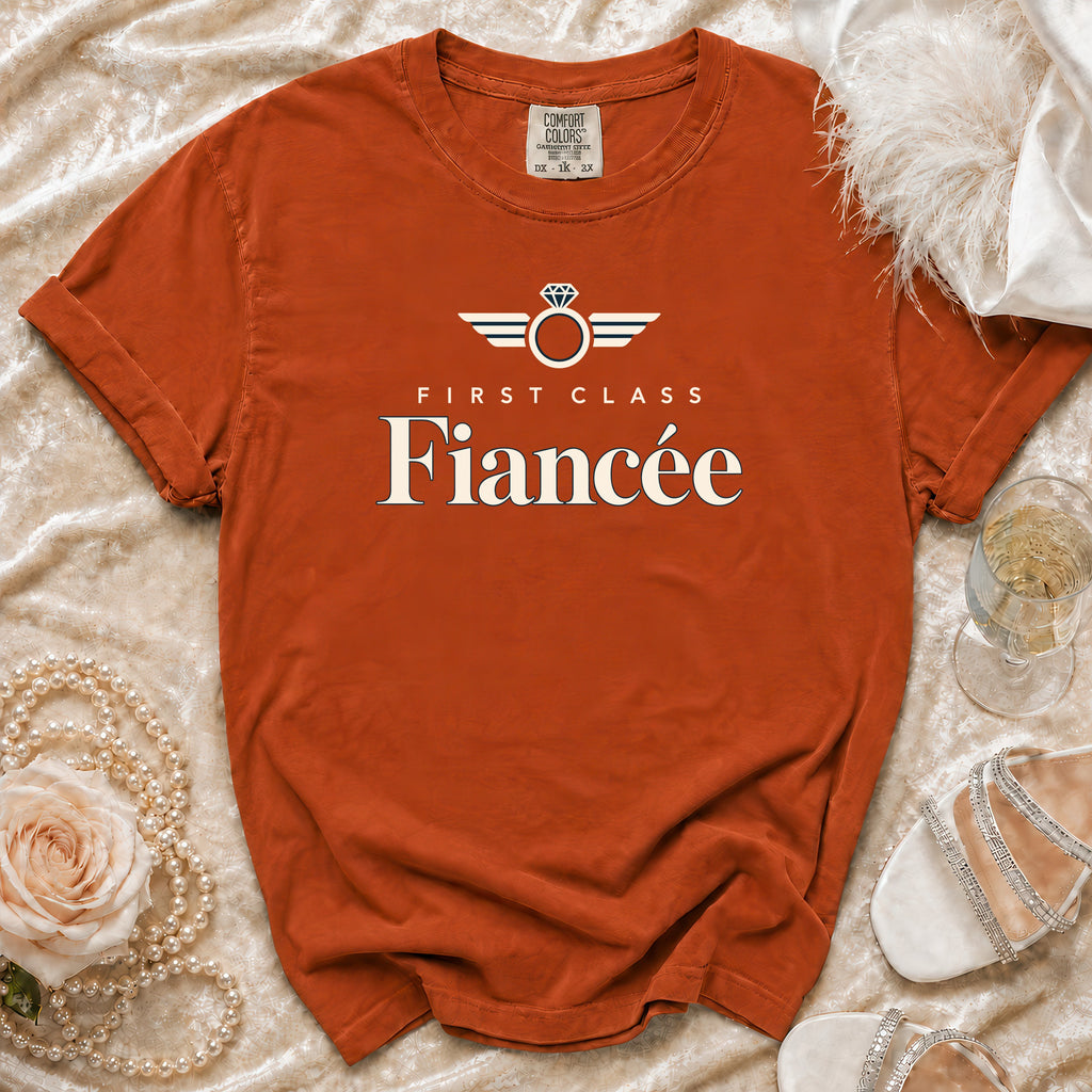 Comfort Colors orange t-shirt with "First Class Fiancée" text and ring graphic.