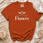 Comfort Colors orange t-shirt with "First Class Fiancée" text and ring graphic.