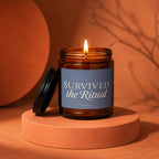 Amber jar candle with lit flame, "SURVIVED the Ritual" text, VOWED below.