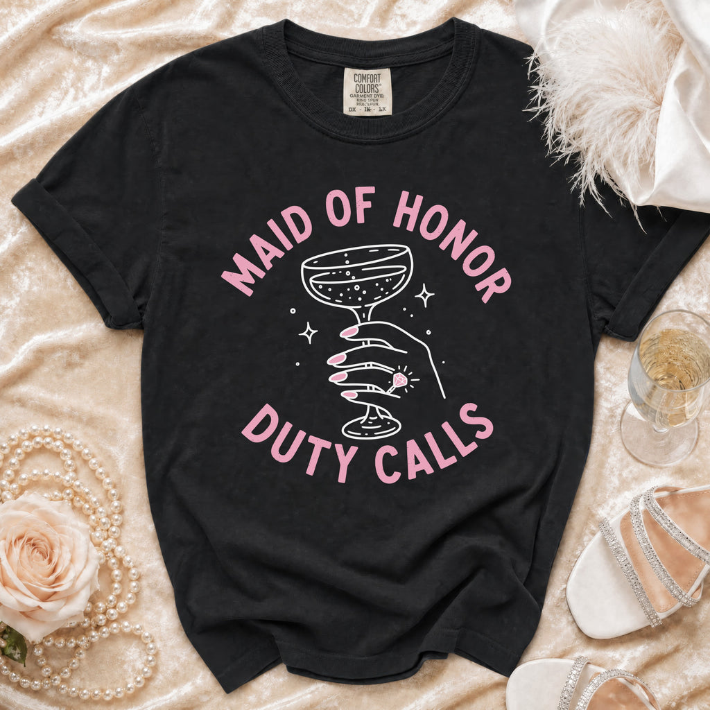 Black t-shirt with "Maid of Honor Duty Calls" text and a hand holding a champagne glass.