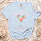 Light blue t-shirt with "Last Splash" cocktail graphic and Sarah's Bach details.