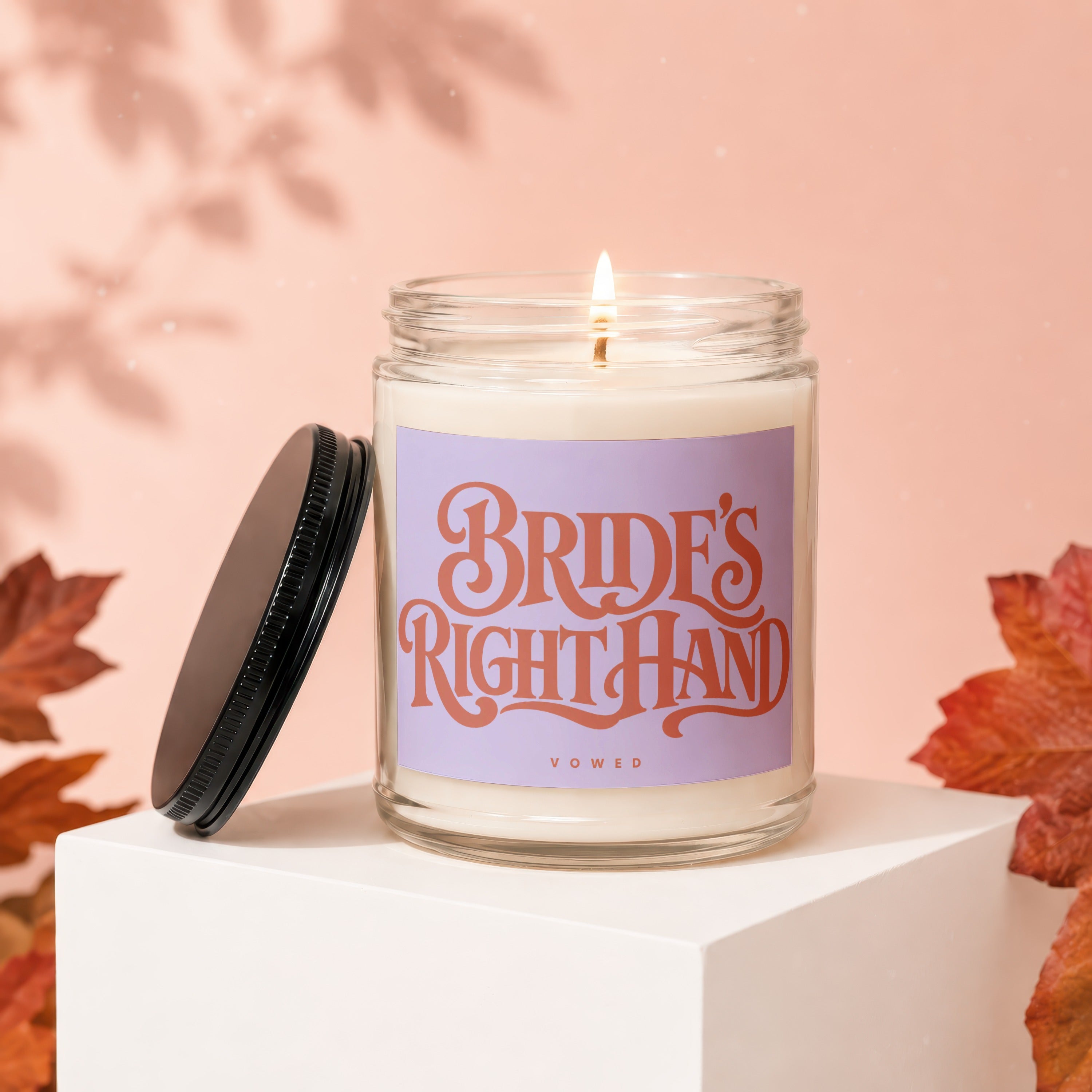 Candle with text "BRIDE'S RIGHT HAND" and "VOWED" on a light purple label.