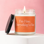 Glass candle with orange label reading "I'm Fine. Everything's Fine. Just Smiling Through The Seating Charts."