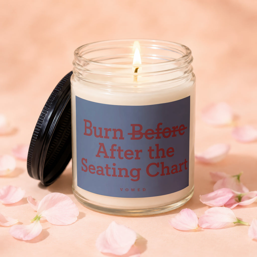 Glass candle with black lid and label reading "Burn Before After the Seating Chart VOWED".