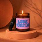 Amber jar candle with pink label that reads "LOVE, FULLY LIT, VOWED".
