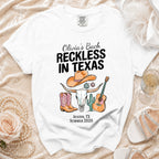 White t-shirt with "Olivia's Bach Reckless in Texas" and Austin graphics.