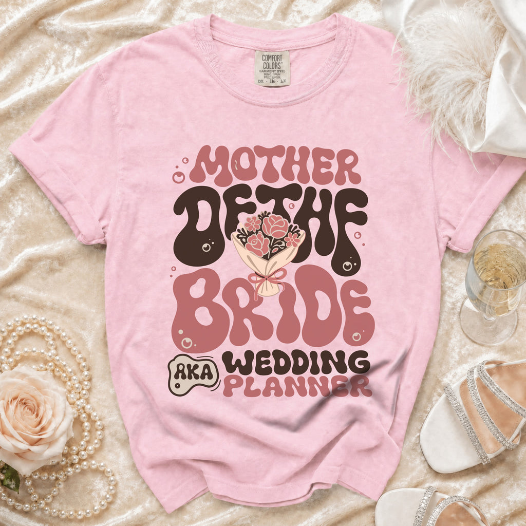 Pink t-shirt with retro "Mother of the Bride Wedding Planner" graphic.