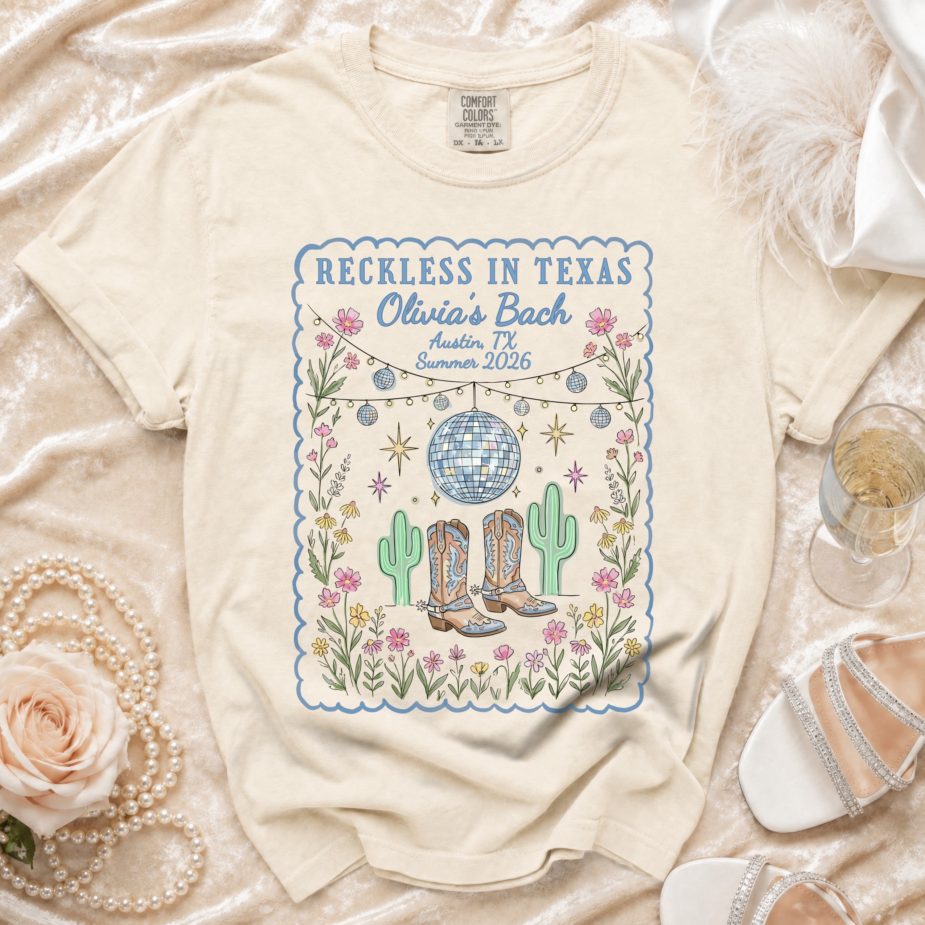 Cream t-shirt with "Reckless in Texas Olivia's Bach Austin, TX Summer 2026" design.