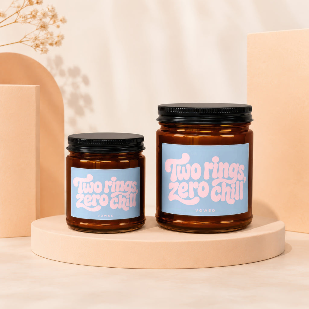 Two amber glass jars with black lids feature blue labels with pink text: "Two rings, zero chill."