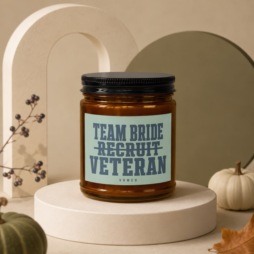 Candle with black lid and label reading "Team Bride Recruit Veteran Vowed."