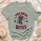 Light green t-shirt with "This Bride Bites" text and gothic bride skull graphic.