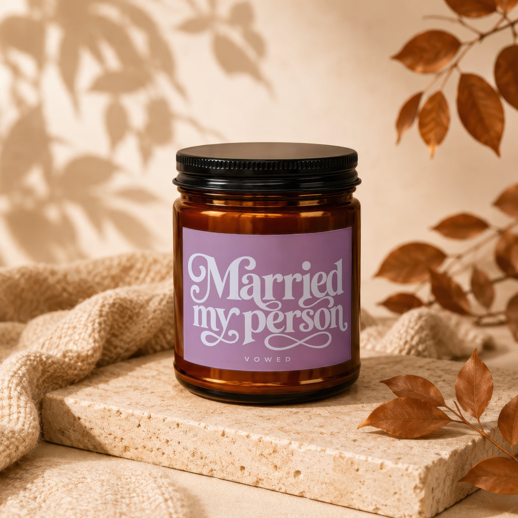Brown glass candle with purple label reading "Married my person" and "vowed".