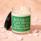 Lit candle in a jar with a green label reading "Bouquet Catching Wasn't in My Job Description."