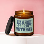 Amber jar candle with lit wick, black lid, and text "Team Bride Recruit Veteran Vowed".