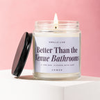 Jar candle with a lit wick and label reading "Better Than the Venue Bathrooms."