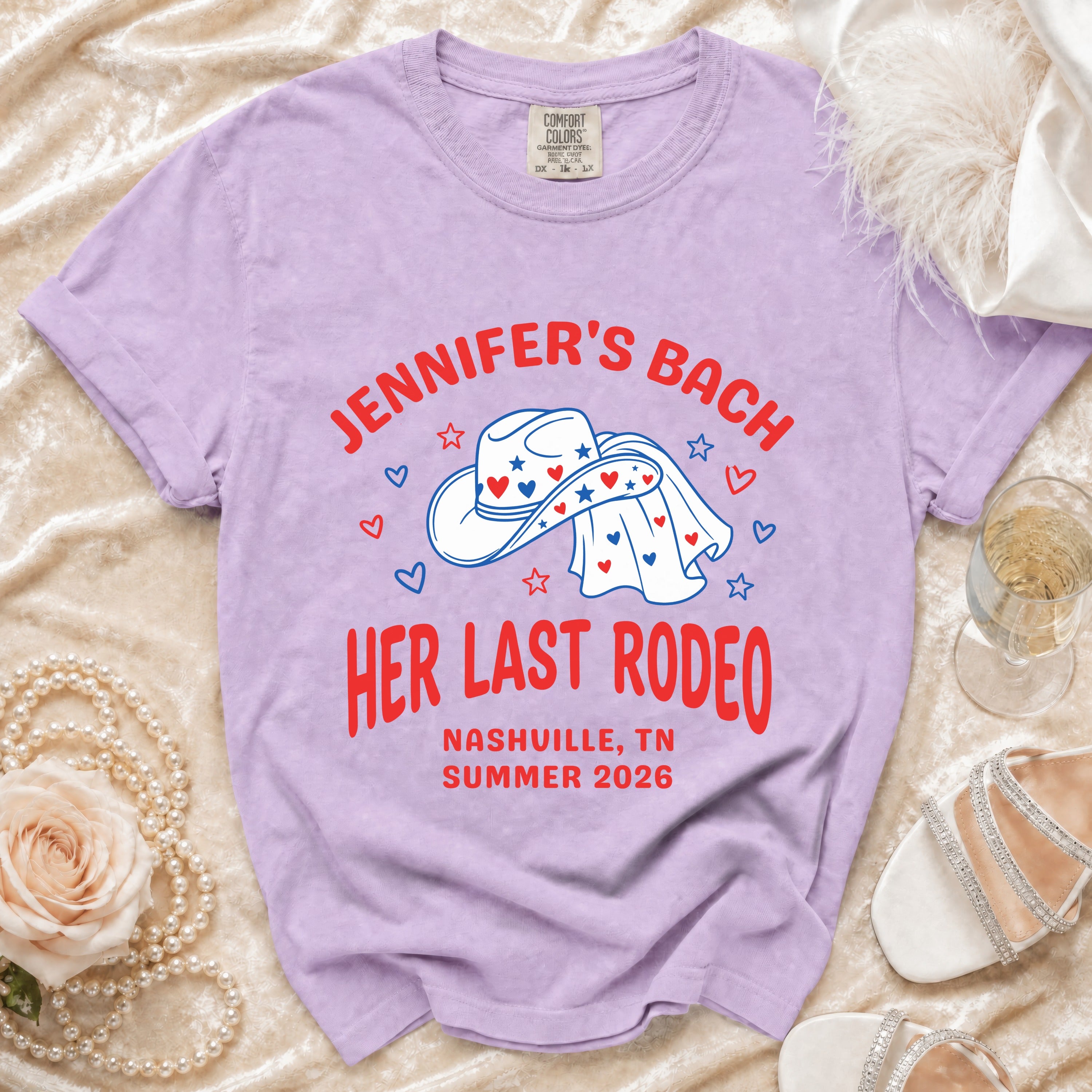 Lavender t-shirt with "Jennifer's Bach Her Last Rodeo" text and cowboy hat.