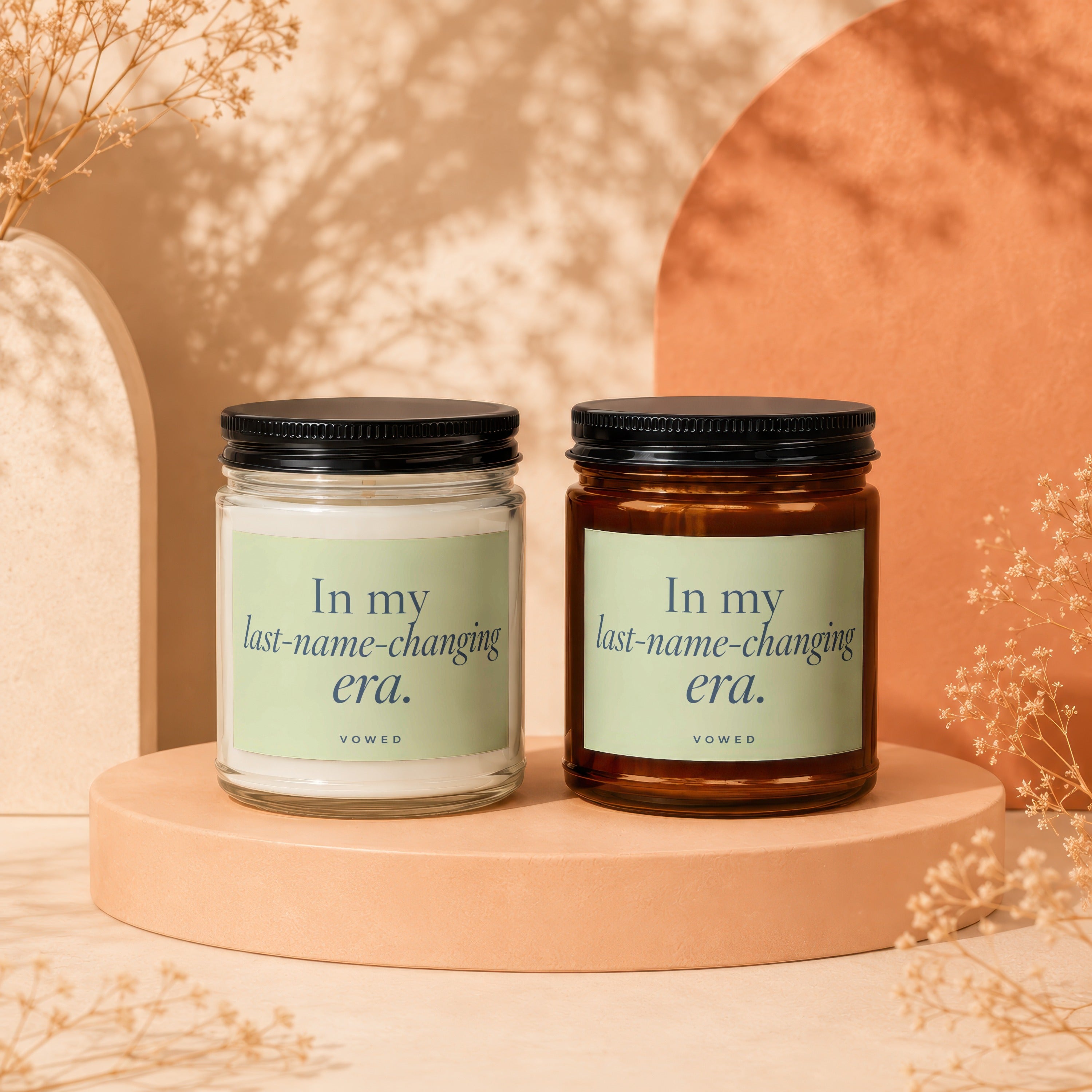 Two candles displayed side-by-side, each with text "In my last-name-changing era."